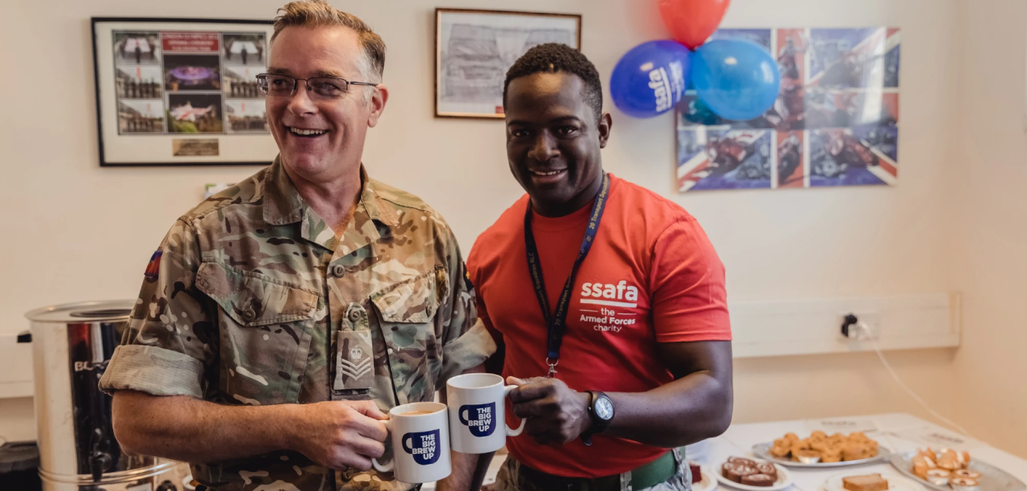 Soldier and ssfa employee cheersing a cup of tea